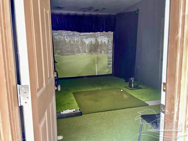 a front view of a house with a garden and trees