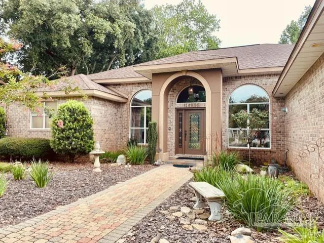 a front view of a house with garden