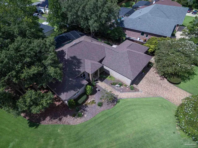 an aerial view of a house with a yard