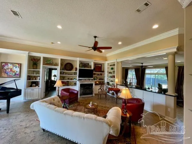 a living room with furniture fireplace and a flat screen tv
