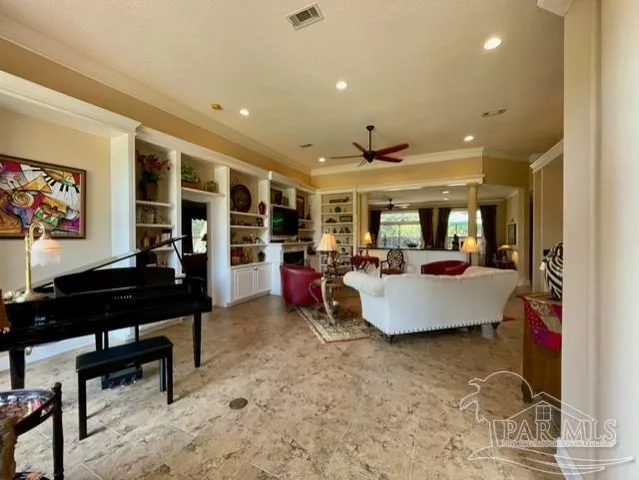 a view of a dining room with furniture and a chandelier