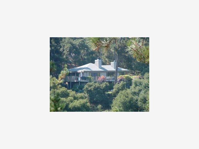 a picture of a bench in front of a house