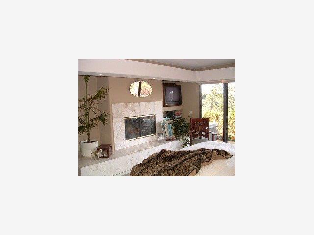 25435 Hidden Mesa Road Monterey, CA 93940 - Photo 2 of 9 a living room with furniture and a fireplace