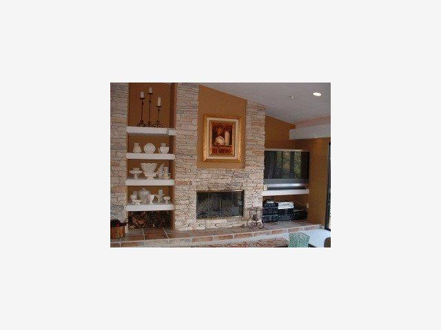 25435 Hidden Mesa Road Monterey, CA 93940 - Photo 4 of 9 a living room with a couch and a fireplace