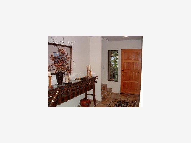 25435 Hidden Mesa Road Monterey, CA 93940 - Photo 8 of 9 a living room with a couch and a potted plant