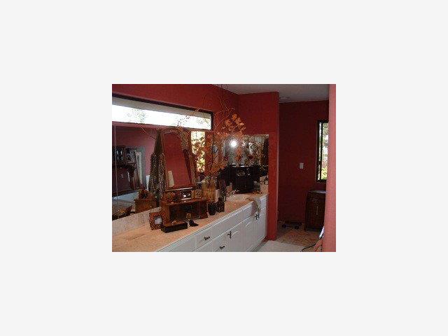 25435 Hidden Mesa Road Monterey, CA 93940 - Photo 9 of 9 a hallway with a table and a mirror