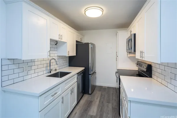 a kitchen with stainless steel appliances granite countertop a sink stove and refrigerator