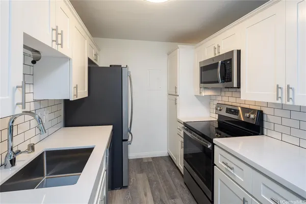 a kitchen with a sink stove and refrigerator