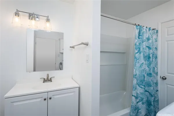 a bathroom with a sink a mirror and shower