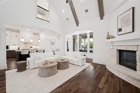 a living room with lots of white furniture and fireplace