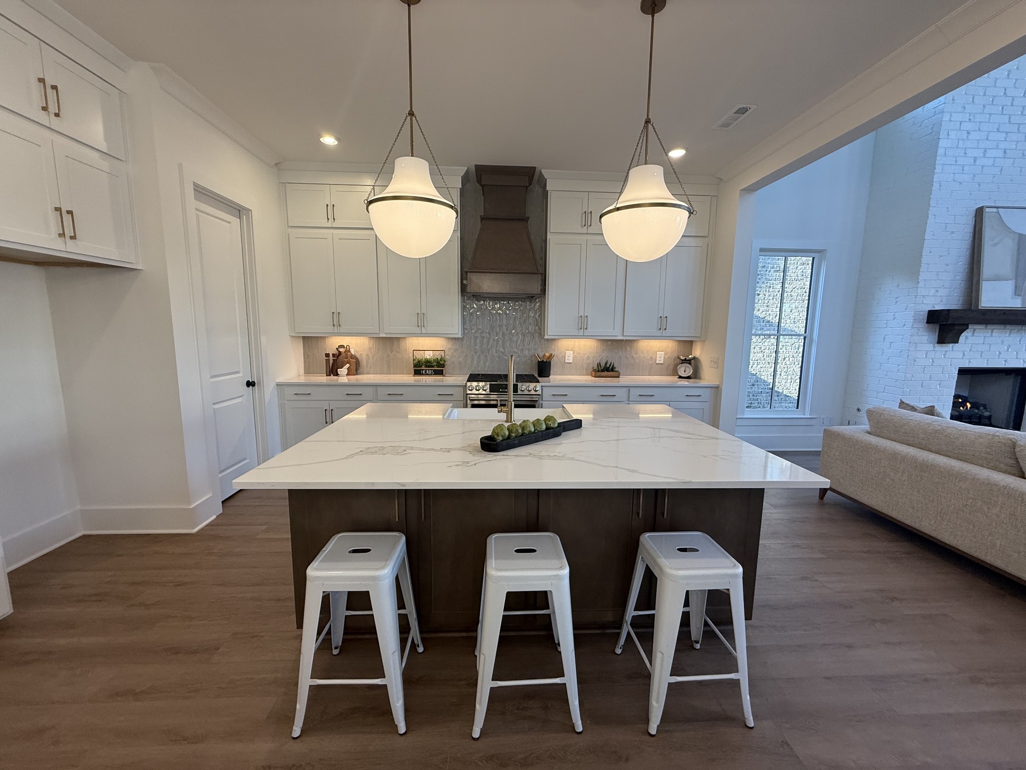317 Deep Crk Road Thompson's Station, TN 37179 - Photo 6 of 24 a kitchen with a dining table chairs and wooden floor
