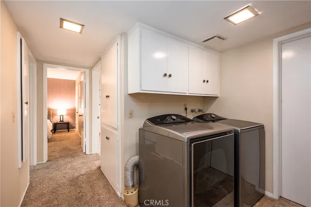 a view of a storage and utility room with washer and dryer