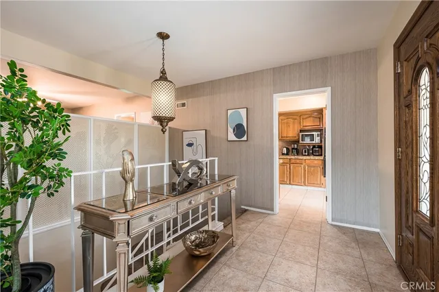 a dining room with furniture and a chandelier