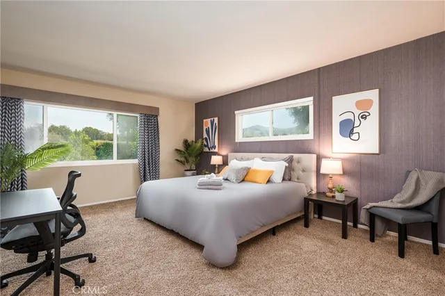 a bedroom with a bed and a large window