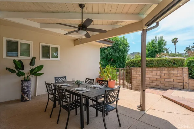a view of a patio with a table and chairs