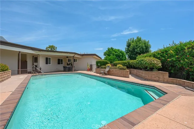 a view of house with swimming pool outdoor seating