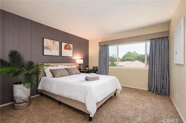 a bedroom with a bed lamp and window