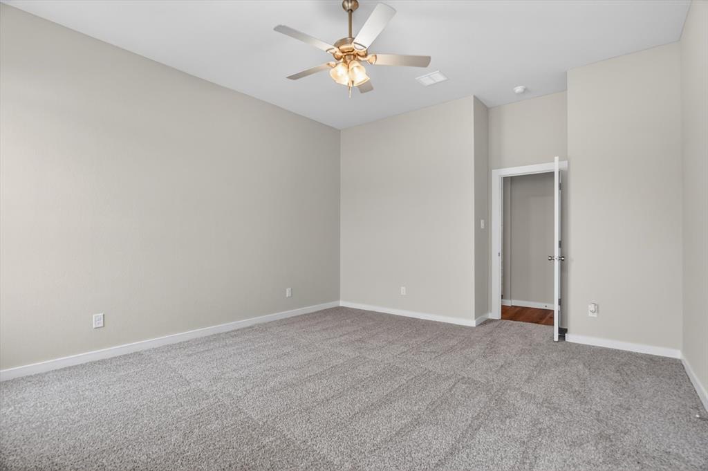 504 Clifton Court Springtown, TX 76082 - Photo 27 of 36 Spacious room featuring neutral wall tones, grey carpeting, a ceiling fan with integrated lighting, and white baseboards