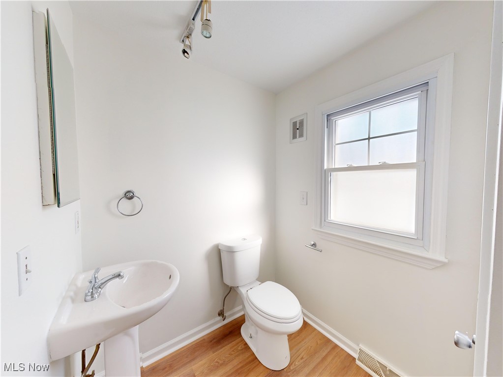 1343 Irene Road Lyndhurst, OH 44124 - Photo 13 of 32 Bathroom featuring sink, hardwood / wood-style flooring, and toilet
