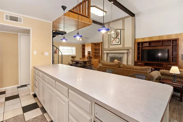 a living room with fireplace furniture and a flat screen tv