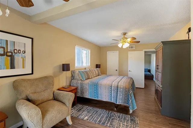 a spacious bedroom with a bed couch and window