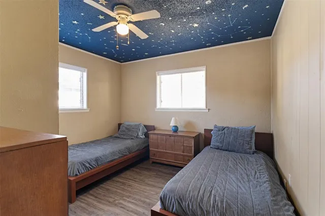 a bedroom with two beds and a chandelier