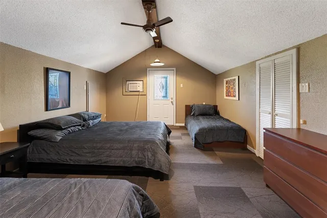 a bedroom with a bed window and a couch