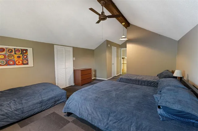 a bedroom with bed dresser and a window