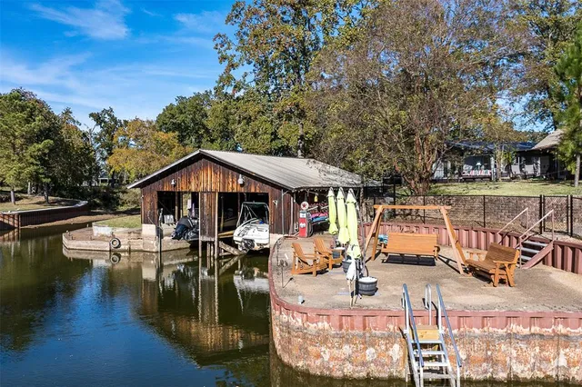 a view of a house with pool and sitting area