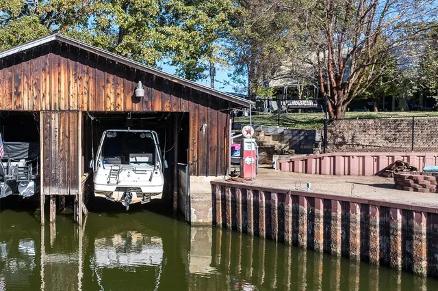 a view of roof deck with wooden fence and plants