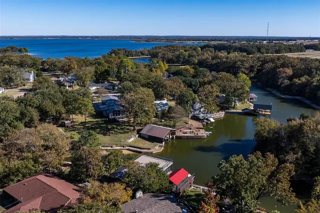 an aerial view of a houses with a lake view