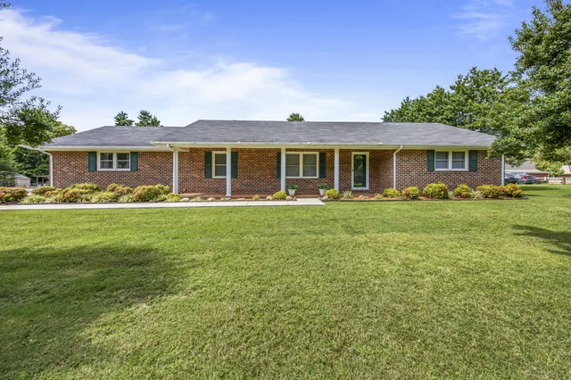 a front view of house with yard and green space