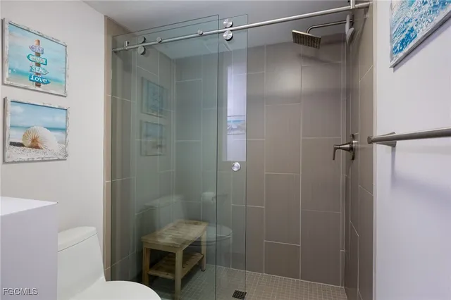 a bathroom with a shower and toilet