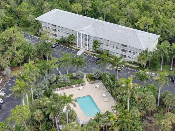 an aerial view of a house with yard and outdoor seating