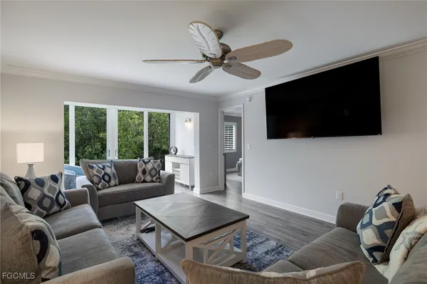 a living room with furniture and a flat screen tv