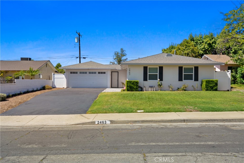 2463 Valhalla Street Pomona, CA 91767 - Photo 1 of 18 a front view of a house with a garden and plants