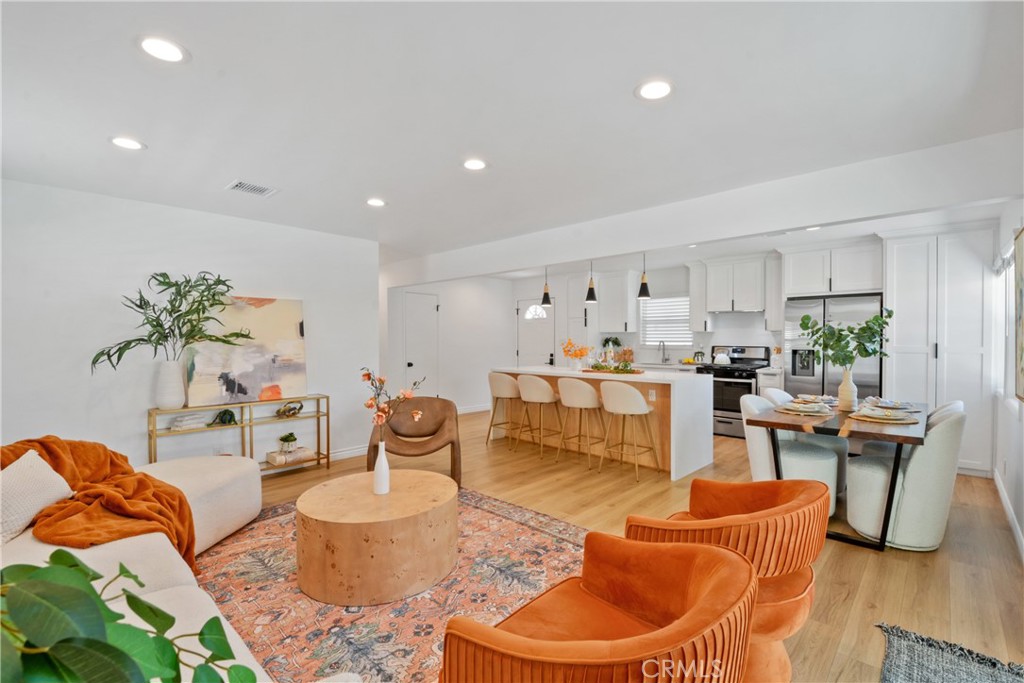 2463 Valhalla Street Pomona, CA 91767 - Photo 4 of 18 a living room with furniture a rug and a dining table