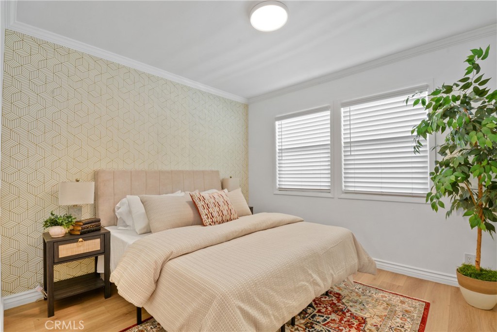 2463 Valhalla Street Pomona, CA 91767 - Photo 8 of 18 a bedroom with a bed and a potted plant