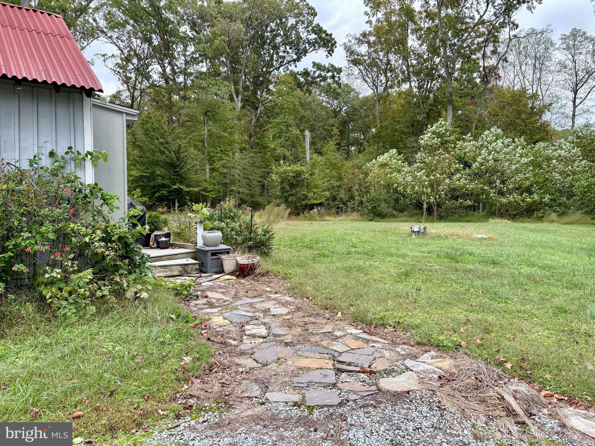 10105 Morgantown Road Newburg, MD 20664 - Photo 3 of 15 a view of backyard with table and chairs and wooden fence
