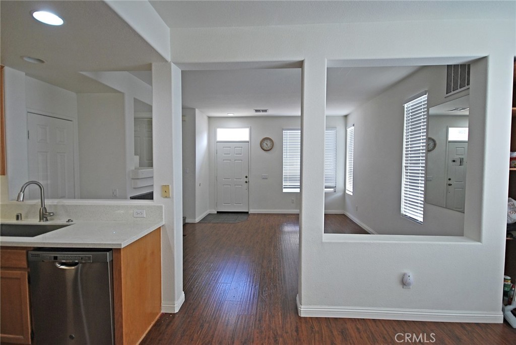 25745 Perlman Place, Unit A Stevenson Ranch, CA 91381 - Photo 11 of 28 a view of a hallway to a room with wooden floor and cabinet