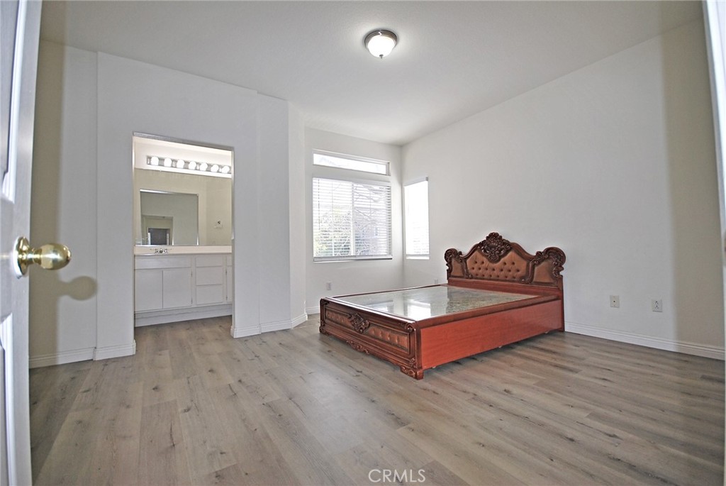 25745 Perlman Place, Unit A Stevenson Ranch, CA 91381 - Photo 13 of 28 a living room with furniture and a wooden floor