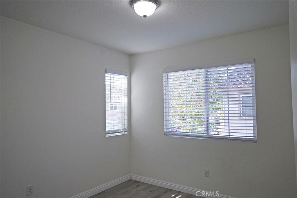 25745 Perlman Place, Unit A Stevenson Ranch, CA 91381 - Photo 20 of 28 wooden floor in an empty room with a window
