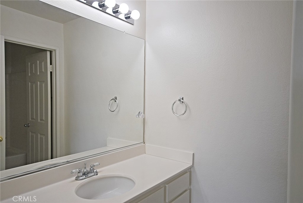 25745 Perlman Place, Unit A Stevenson Ranch, CA 91381 - Photo 22 of 28 a bathroom with a sink and a mirror