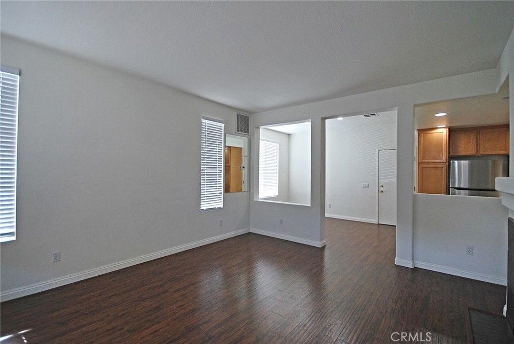 25745 Perlman Place, Unit A Stevenson Ranch, CA 91381 - Photo 4 of 28 an empty room with wooden floor and windows