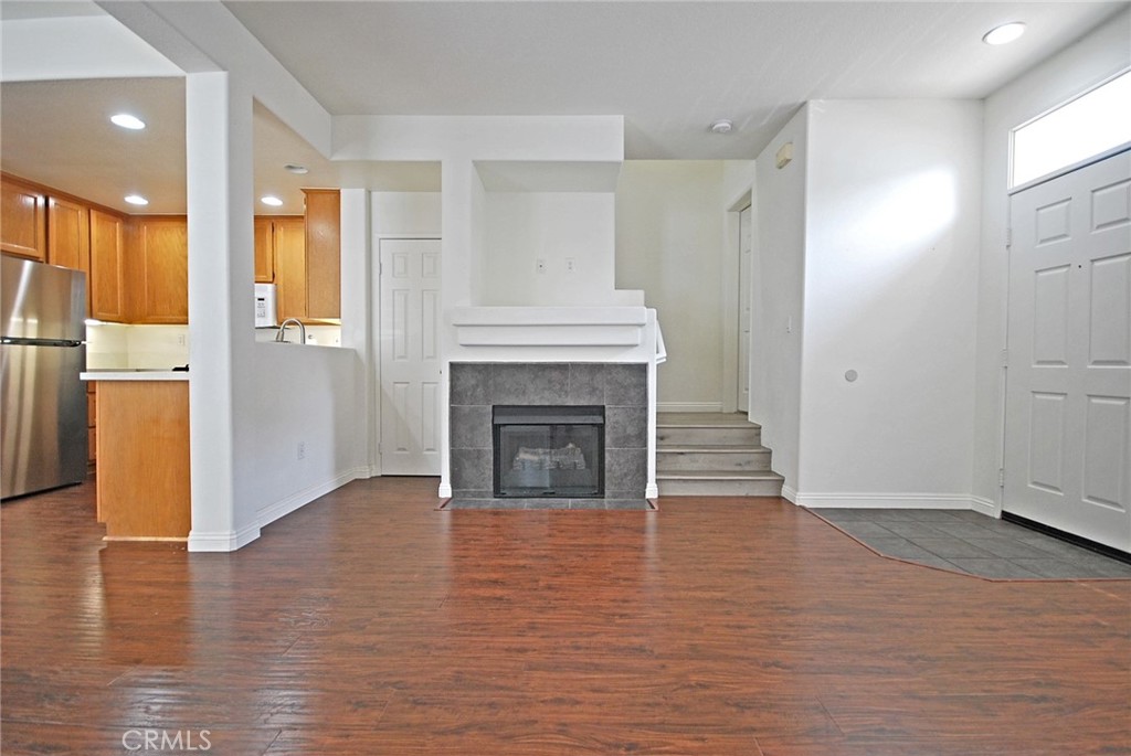 25745 Perlman Place, Unit A Stevenson Ranch, CA 91381 - Photo 6 of 28 a view of a livingroom with wooden floor and a kitchen