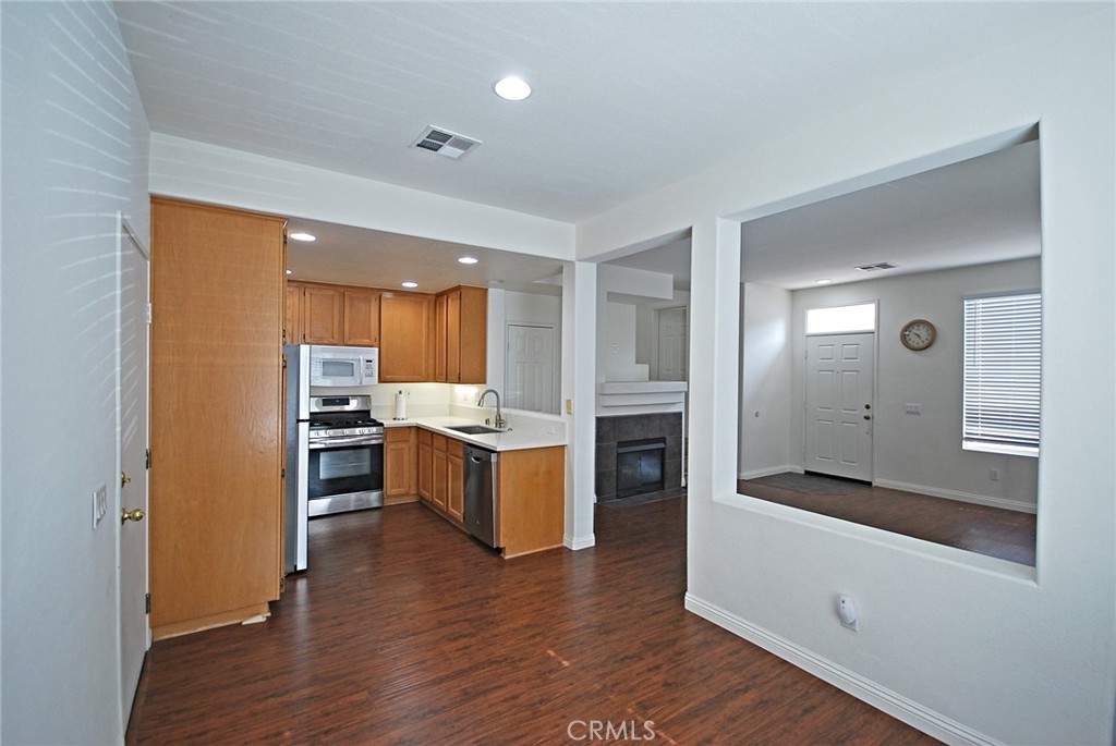 25745 Perlman Place, Unit A Stevenson Ranch, CA 91381 - Photo 7 of 28 a kitchen with a refrigerator and a stove top oven