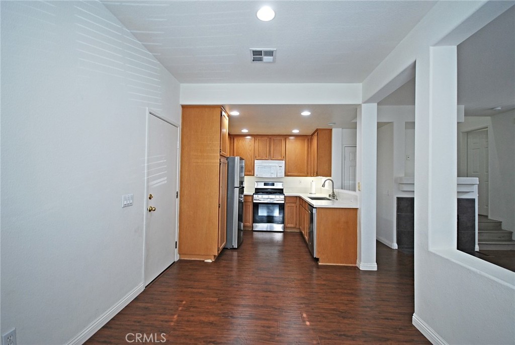 25745 Perlman Place, Unit A Stevenson Ranch, CA 91381 - Photo 8 of 28 a open kitchen with a sink and cabinets