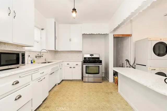 a kitchen with a sink a stove and refrigerator