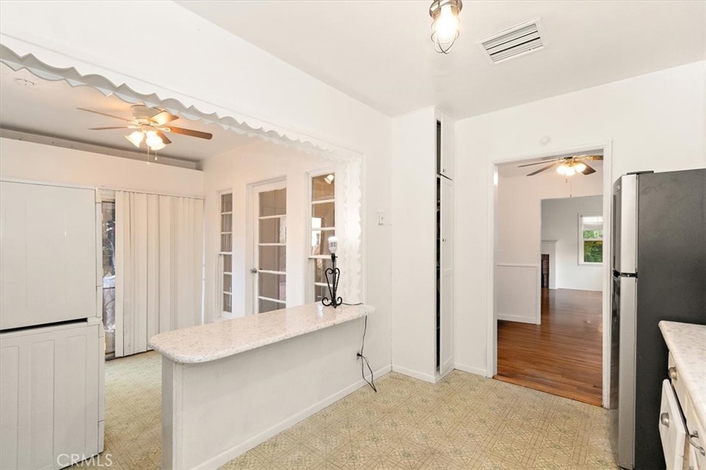 14248 Friar Street Van Nuys, CA 91401 - Photo 13 of 36 a view of kitchen with windows and refrigerator