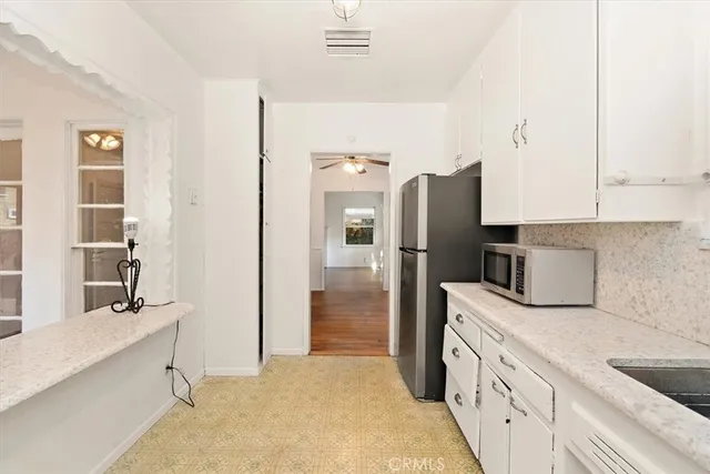 a kitchen with a refrigerator and a sink